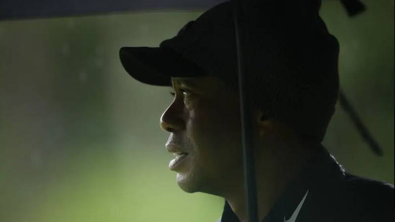 Tiger Woods watches on the 13th hole during the weather delayed third round of the Masters golf...