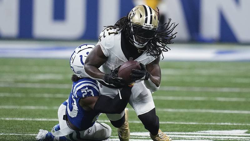 Saints running back Alvin Kamara (41) is tackled by Indianapolis cornerback Dallis Flowers (33)...