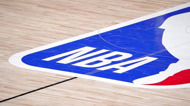 FILE - In this Sept. 2, 2020, file photo, the NBA logo is displayed at center court during an...