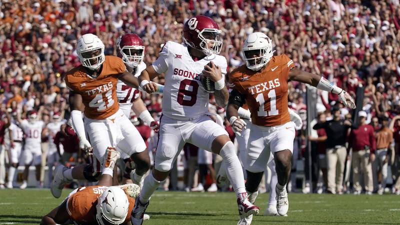 Oklahoma quarterback Dillon Gabriel (8) scores a touchdown ahead of Texas defenders Alfred...