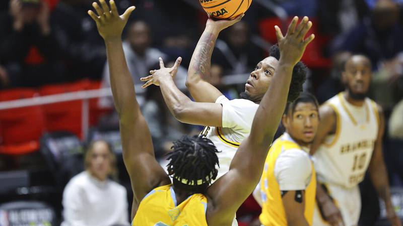 Grambling State guard Tra'Michael Moton, rear, shoots over Southern forward Festus Ndumanya in...