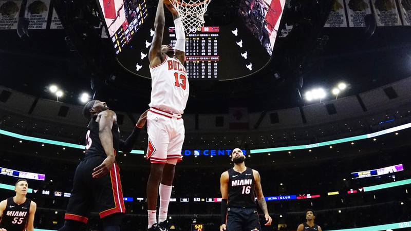 Miami Heat center Bam Adebayo, front left, defends Chicago Bulls forward Torrey Craig (13) who...